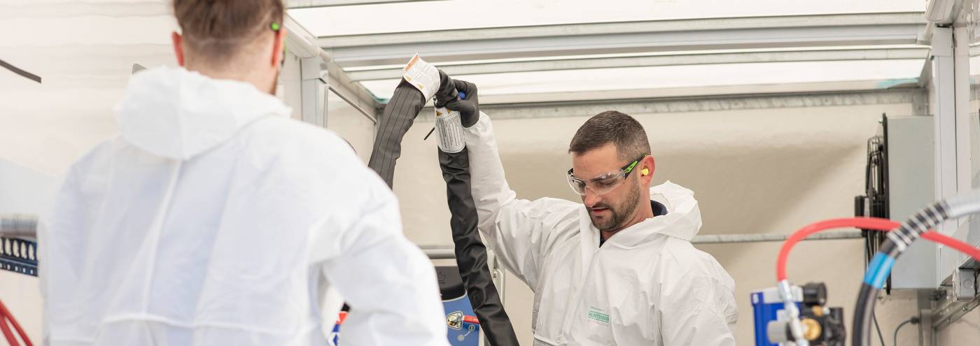 two men looking prepping equipment