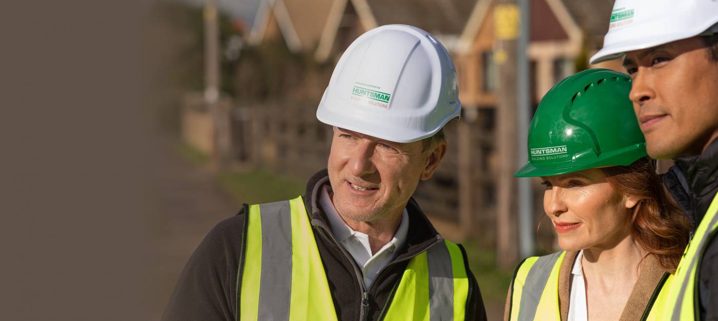 2 builders and an architect assessing a building site