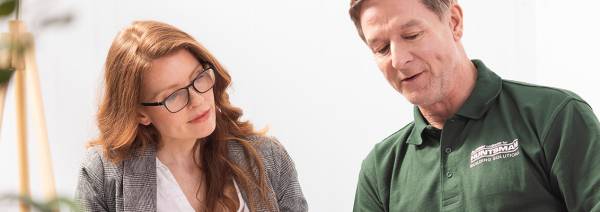 Lady with glasses speaking with building expert