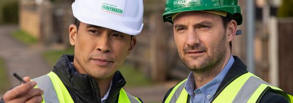 2 men inward hats at building site