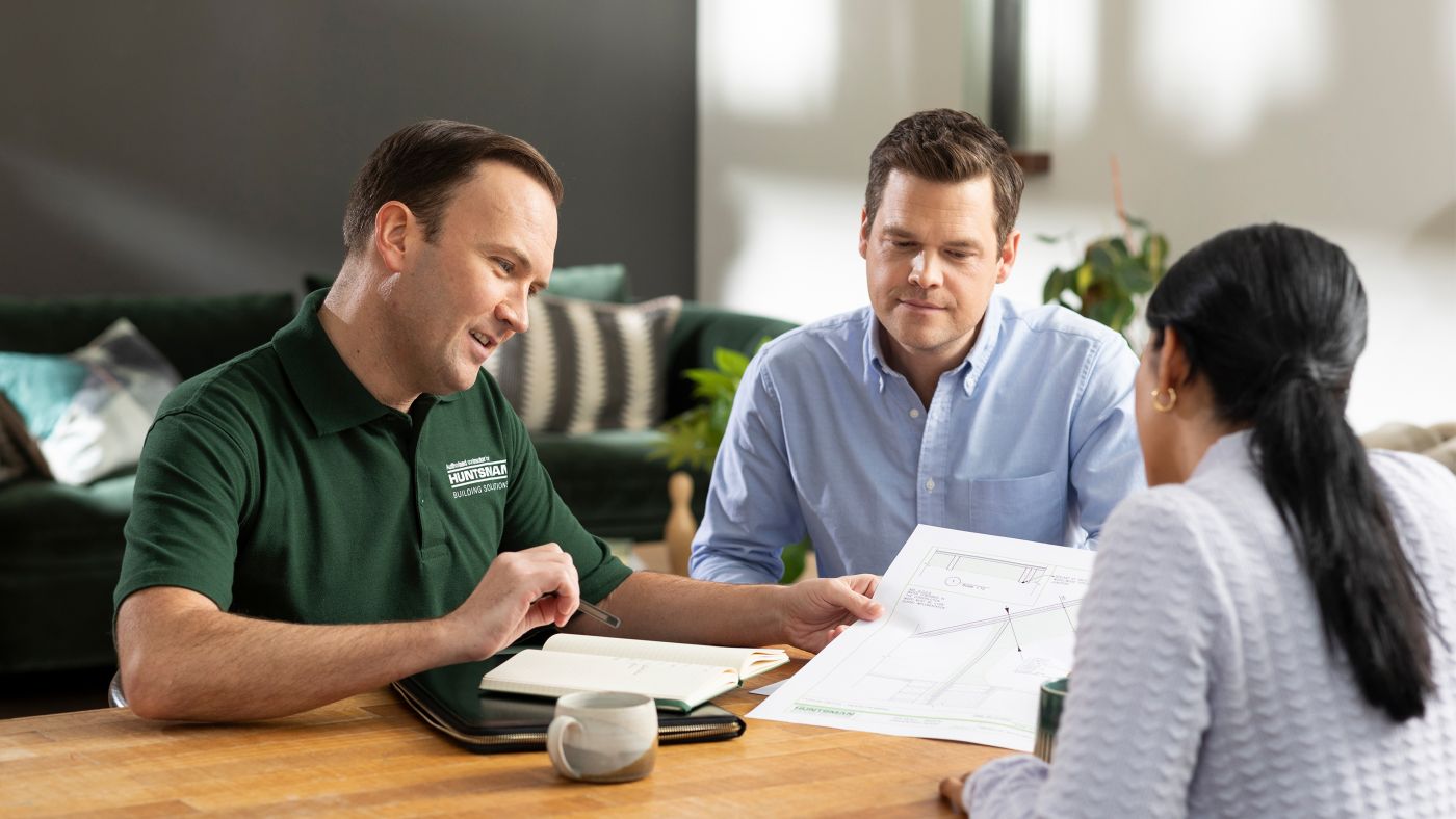 Huntsman installer explaining details to customers